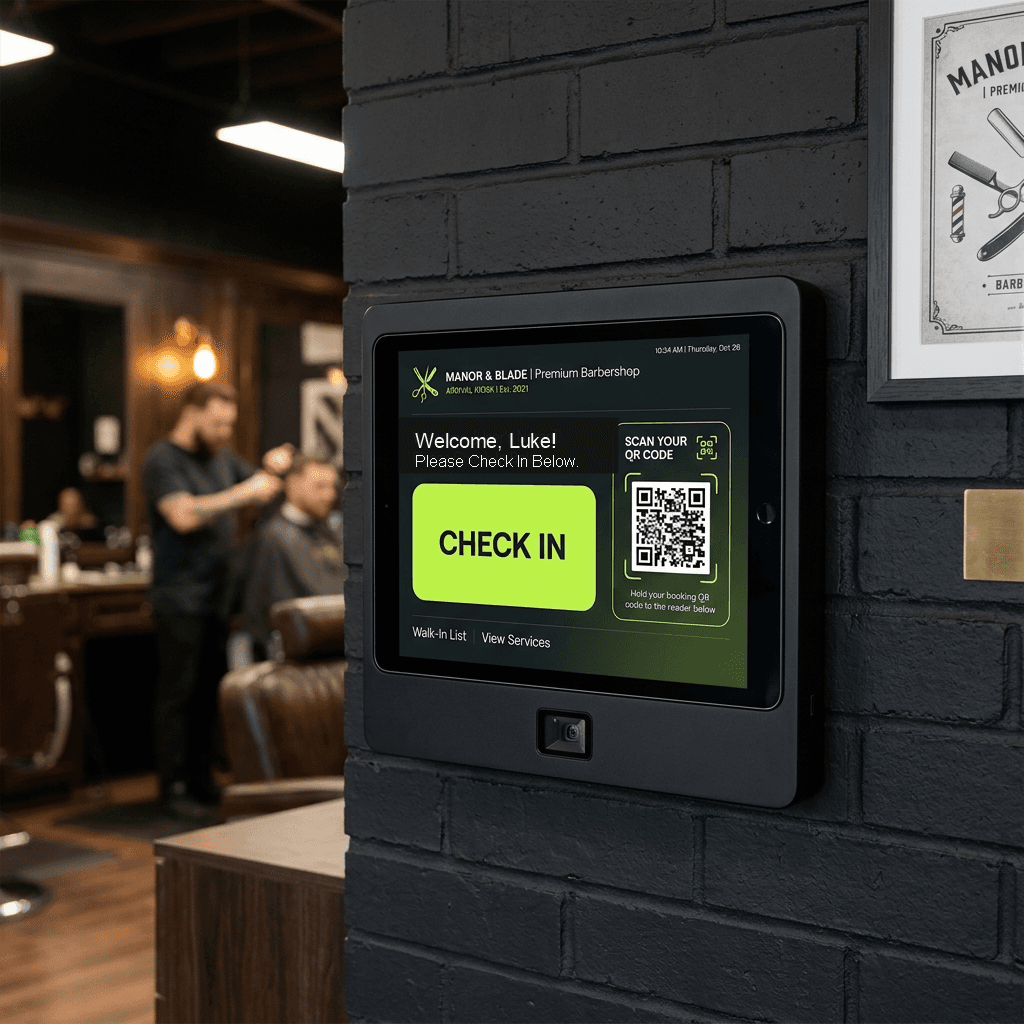 Wall check-in screen in a barbershop with a barber cutting hair in the background
